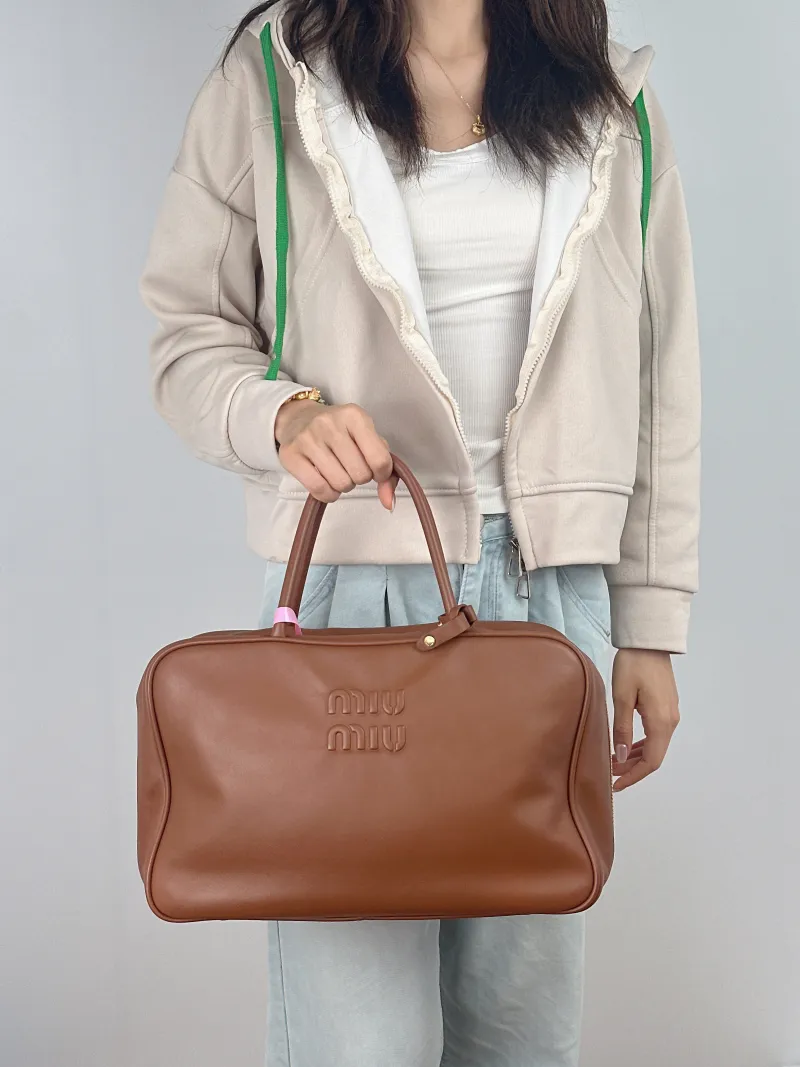 Miumiu Top Handle Bag Beau CC alfskin Large 34 × 10 × 23 cm — on-model view 2 of 2