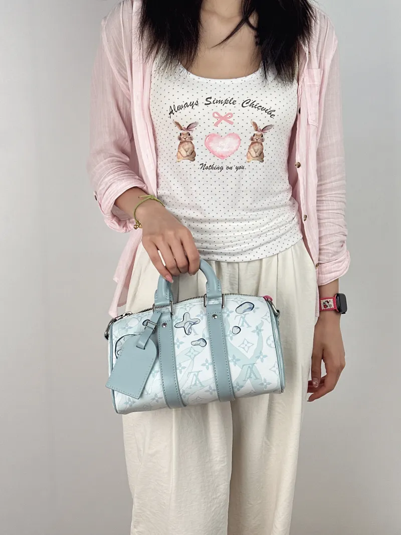 Louis Vuitton Crossbody Bag Keepall 25 Blue PVC Medium25 × 11 × 15 cm — on-model view 1 of 3