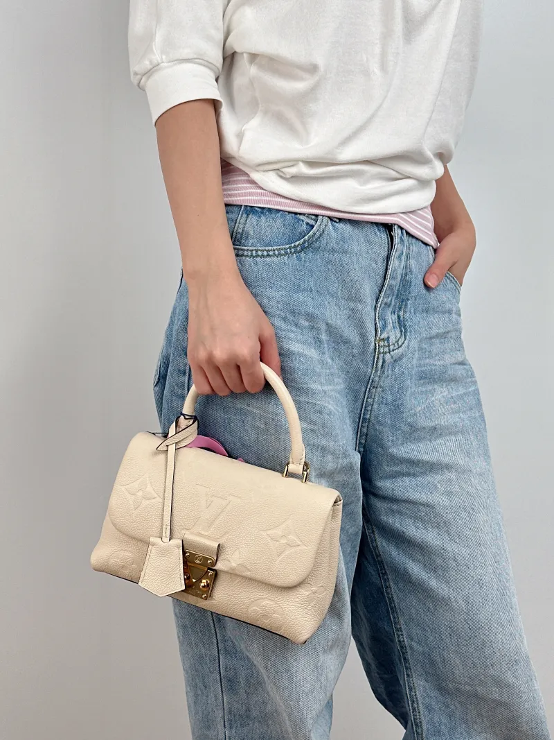 Louis Vuitton Crossbody Bag MADELEINE White Monogram Empreinte Embossed Calfskin BB 24 × 8.5 × 17 cm — on-model view 2 of 3