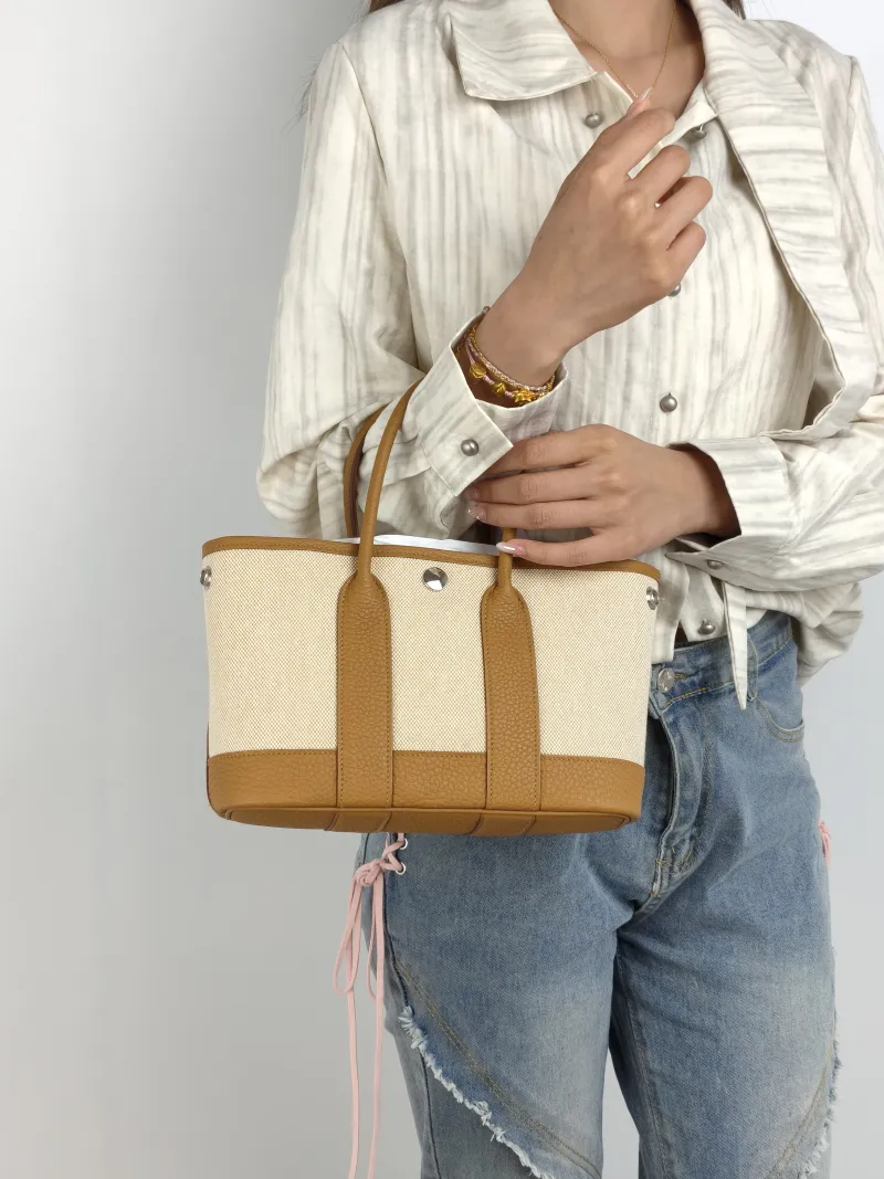 Hermès Top Handle Bag Neo Garden 23 Mini Canvas · Negonda Calfskin Mini 23 × 10 × 16 cm G — on-model view 1 of 2