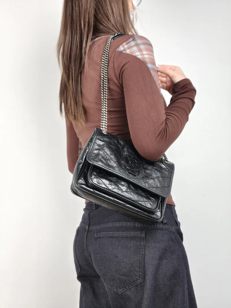 SAINT LAURENT Crossbody Bag Niki Black Waxed Leather Calfskin Small 21 × 7.5 × 16 cm — on-model view 1 of 2