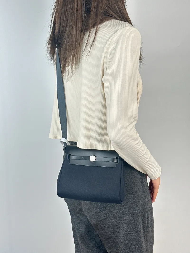 Hermès Crossbody Bag Herbag Zip 20Black Calfskin，Canvasmini20.5 × 7 × 16.5 cm — on-model view 1 of 2