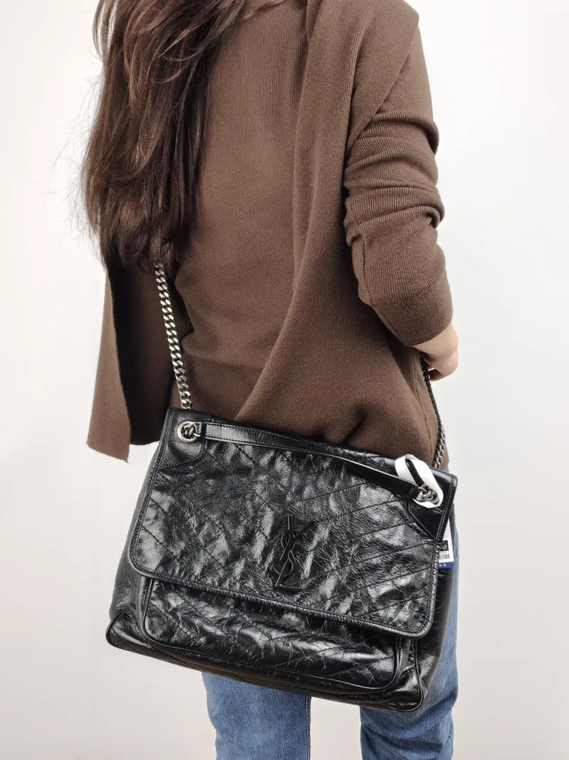 SAINT LAURENT Crossbody Bag Niki D Waxed Leather Calfskin Large 32 × 9 × 23 cm — on-model view 1 of 2