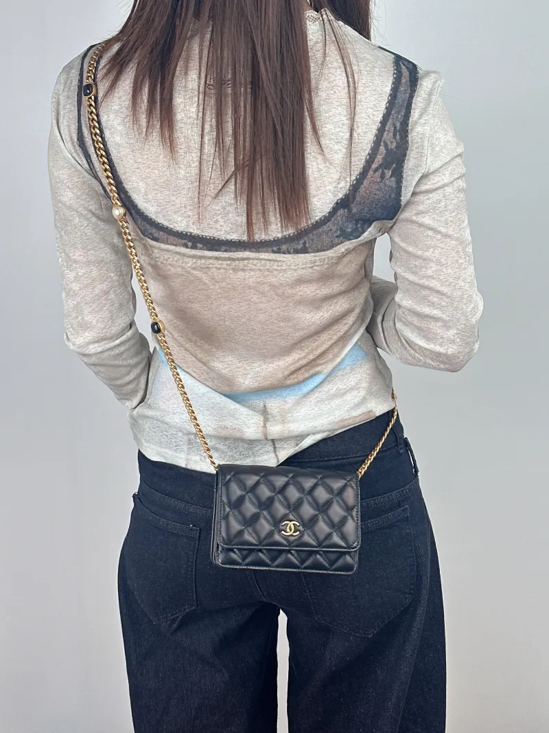 Chanel Crossbody Bag22b woc Black Lambskin15.5 × 4.5 × 11 cm — on-model view 1 of 2