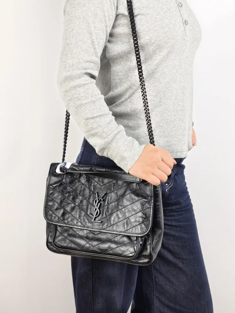 SAINT LAURENT Crossbody Bag Niki Black Waxed Leather Calfskin Medium 28 × 8.5 × 20 cm — on-model view 2 of 3