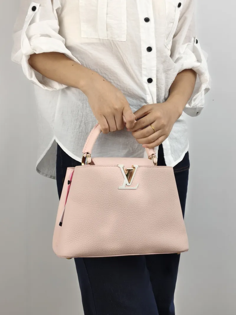 Louis Vuitton Top Handle Bag Capucines Pink Calfskin BB 27 × 9 × 17.5 cm — on-model view 1 of 3