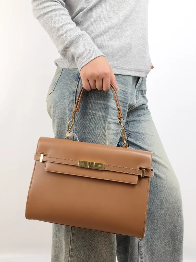 SAINT LAURENT MANHATTAN Caramel Calfskin Small 32 × 10 × 22.5 cm — on-model view 1 of 2