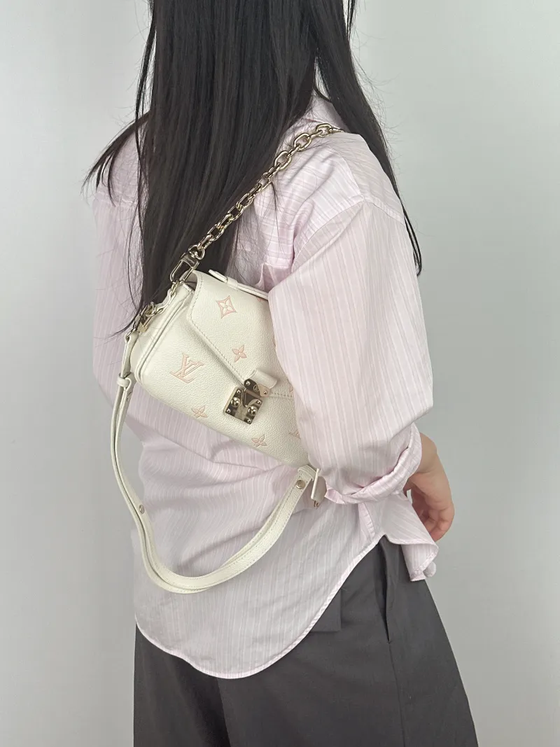 Louis Vuitton Crossbody Bag Pochette Métis East West White · Pink Calfskin Small 21.5 × 6 × 13.5 cm — on-model view 1 of 3