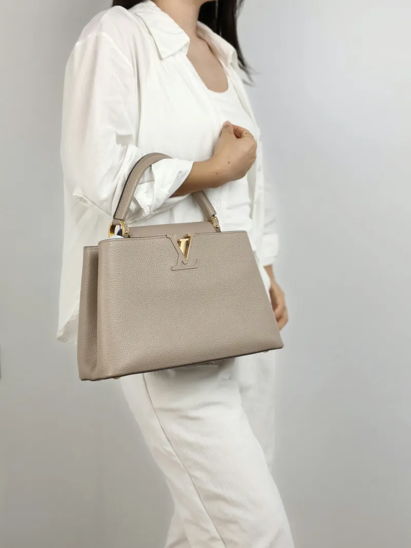 Louis Vuitton Top Handle Bag Capucines Grey Calfskin Medium 31.5 × 11 × 20 cm — on-model view 1 of 2