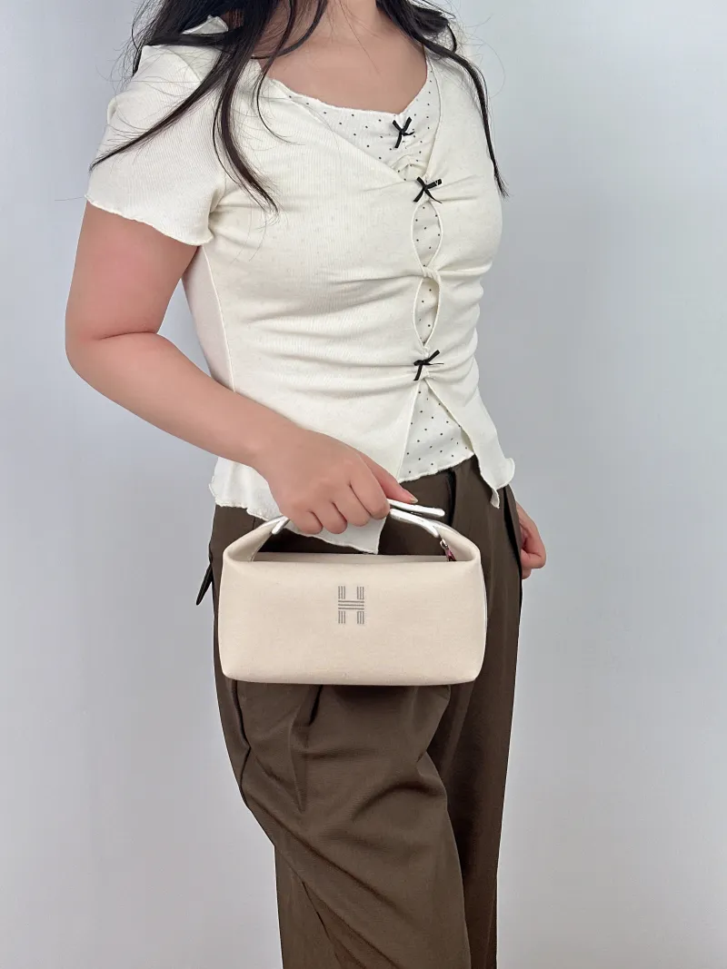 Hermès Top Handle Bagbride-a-brac White Canvas Small21 × 12 × 27 cm — on-model view 1 of 2