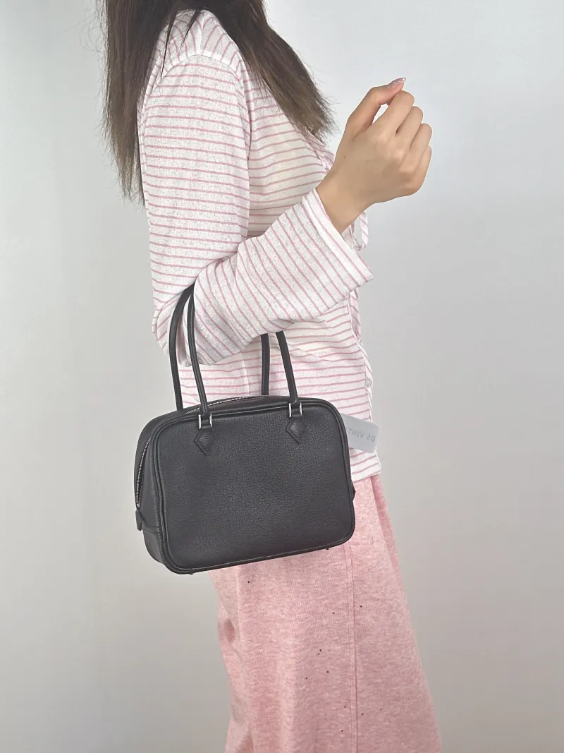 Hermès Top Handle Bag Plume 21 Black Lambskinmini21 × 8 × 15 cm — on-model view 2 of 2
