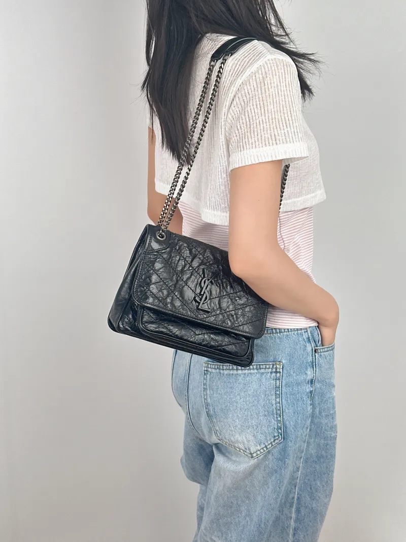 SAINT LAURENT Crossbody Bag Niki D Waxed Leather Calfskin Small21 × 7.5 × 16 cm — on-model view 1 of 3