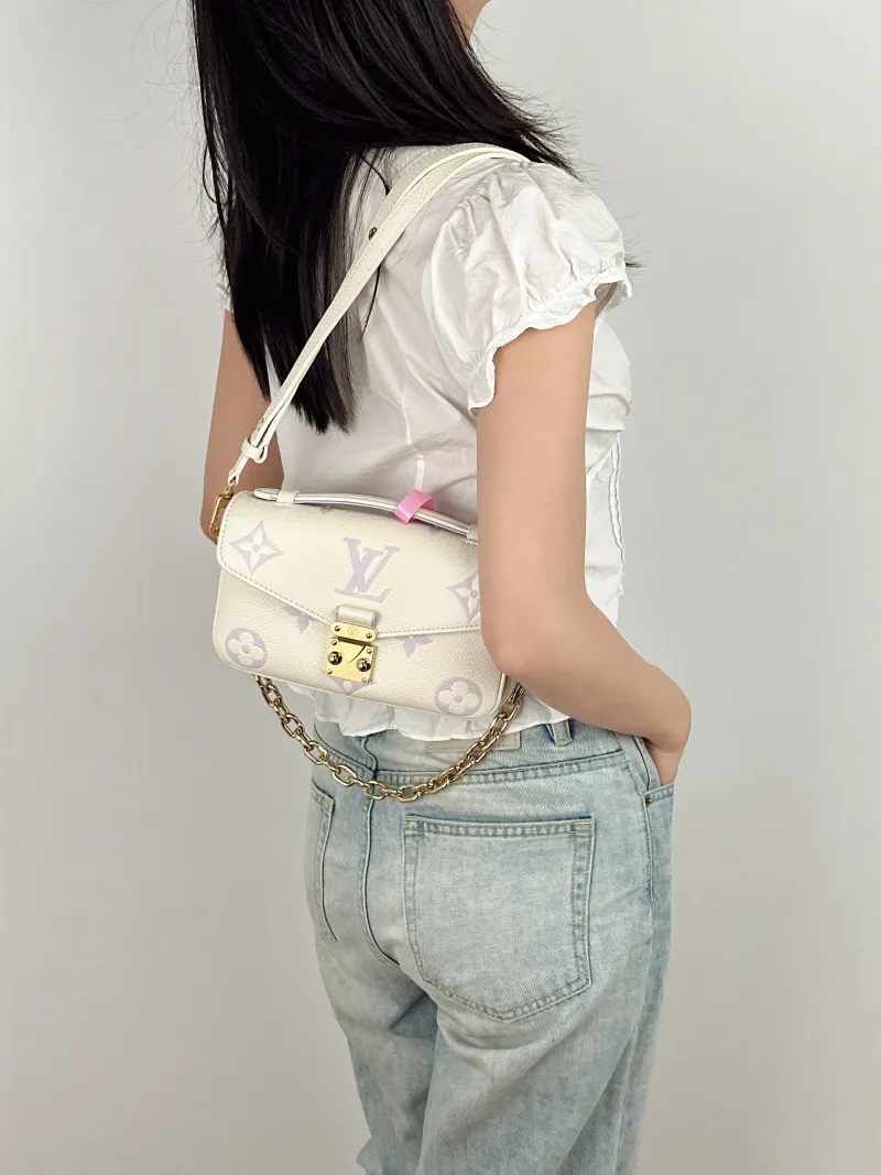 Louis Vuitton Crossbody Bag Pochette Métis East West White · Monogram Empreinte Embossed Calfskin Small 21.5 × 6 × 13.5 cm — on-model view 1 of 3