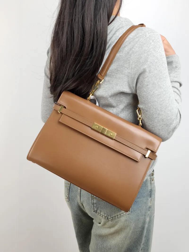 SAINT LAURENT MANHATTAN Caramel Calfskin Small 32 × 10 × 22.5 cm — on-model view 2 of 2