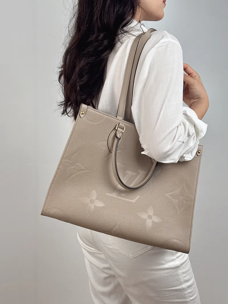 Louis Vuitton Shoulder Bag Onthego Medium Monogram Empreinte Embossed Calfskin Medium 35 × 14 × 27 cm — on-model view 3 of 3