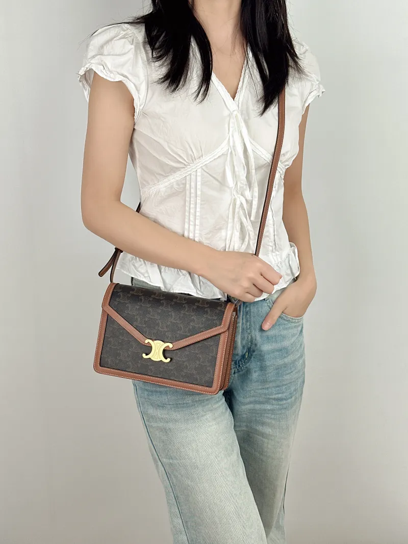 CELINE Crossbody Bag ENVELOPPE TRIOMPHE Monogram PVC Medium 22 × 5 × 15 cm — on-model view 1 of 2