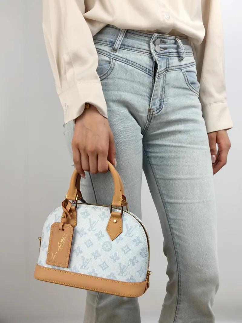 Louis Vuitton Top Handle Bag Alma BB Blue PVC BB 23.5 × 11.5 × 17.5 cm — on-model view 1 of 2