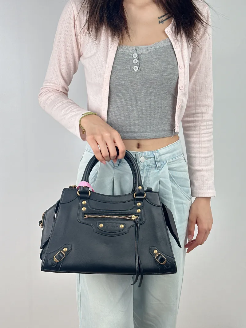 BALENCIAGA Crossbody Bag Neo Classic Black with Gold-Tone Hardware Calfskin Small 33 × 15.5 × 21 cm — on-model view 1 of 3