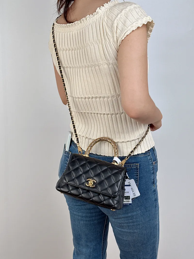 Chanel Top Handle Bag22a Coco Handle​Black CC alfskinmini19 × 9 × 13 cm — on-model view 2 of 2