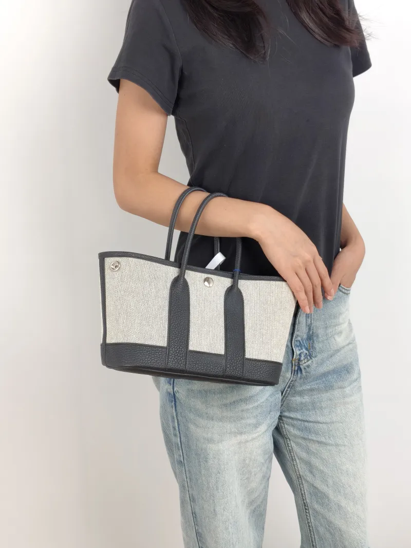 Hermès Top Handle Bag Neo Garden 23 Mini Black · Beige Canvas · Negonda Calfskin Mini 23 × 10 × 16 cm k — on-model view 1 of 2