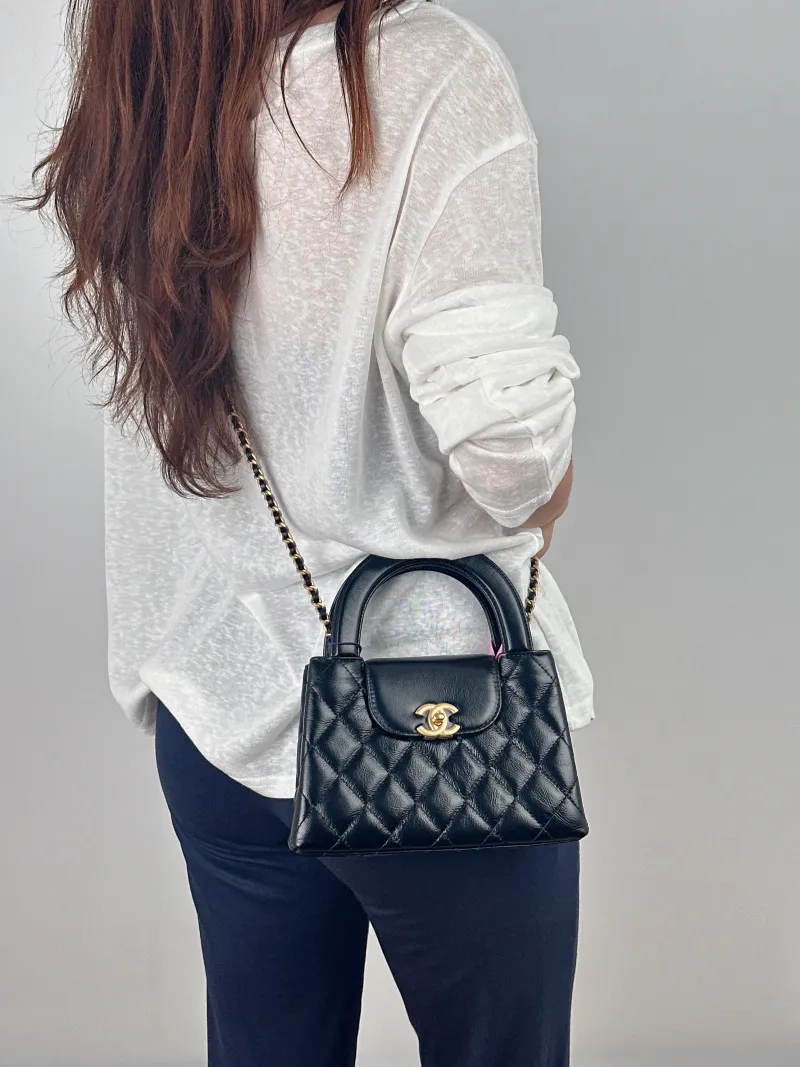 Chanel Crossbody Bag Kelly Black Waxed Leather Mini 19 × 7 × 13 cm — on-model view 2 of 2