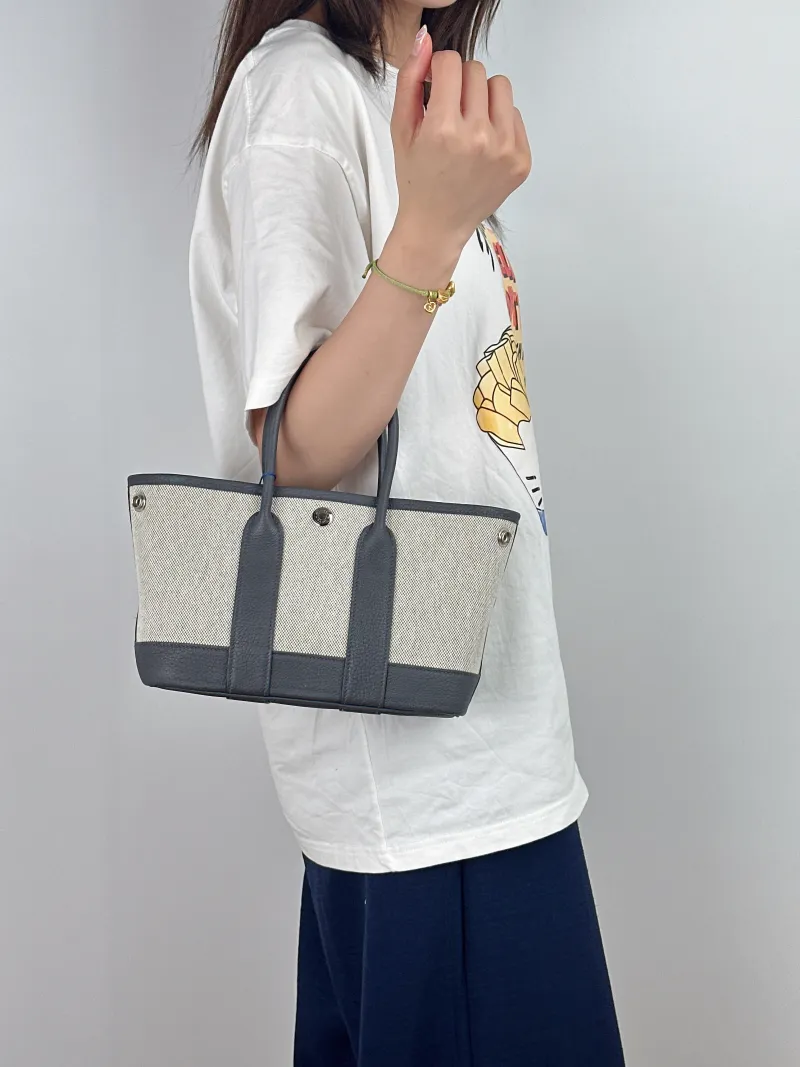 Hermès Top Handle Bag Neo Garden 23 Mini Beige · Canvas · Negonda Calfskinmini23 × 10 × 16 cm — on-model view 1 of 2
