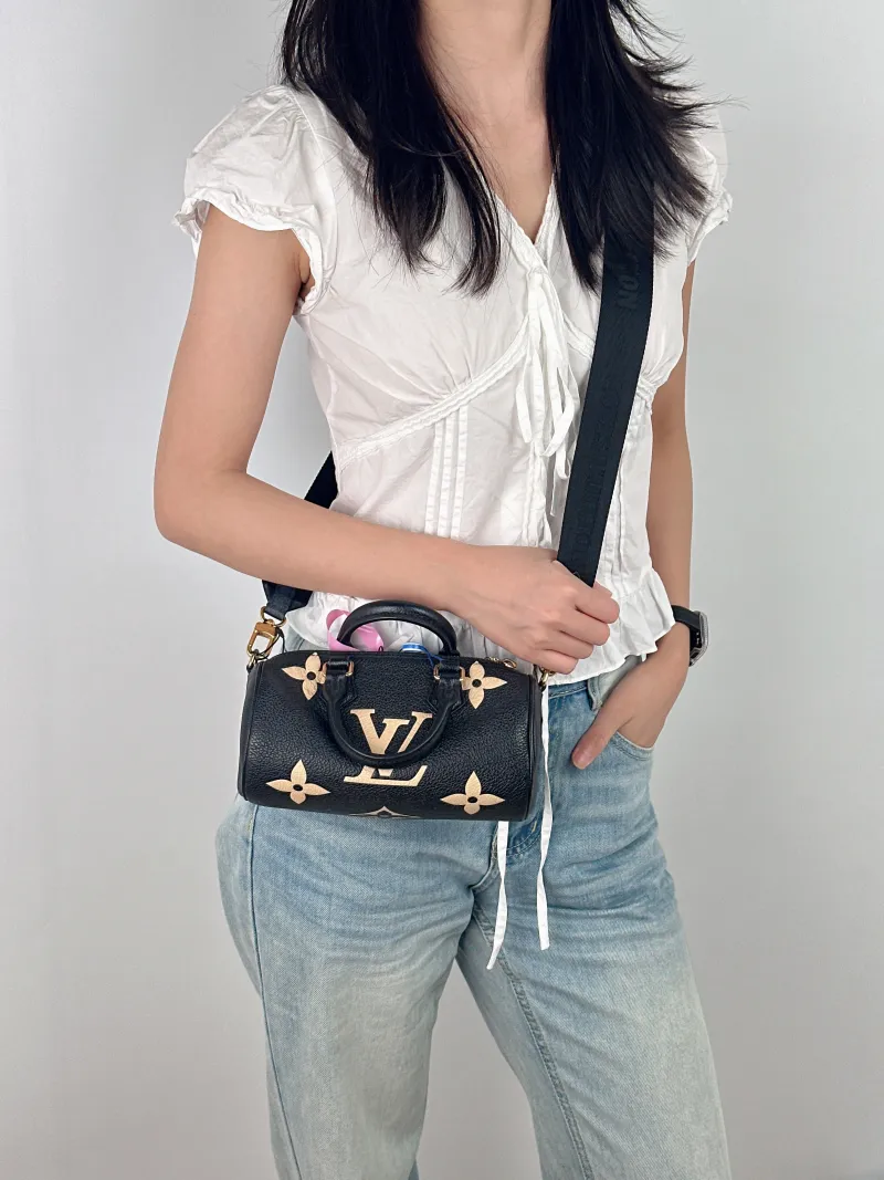 Louis Vuitton Crossbody Bag Papillon Black · White Monogram Empreinte Embossed Calfskin BB 20 × 10 × 10 cm — on-model view 1 of 3