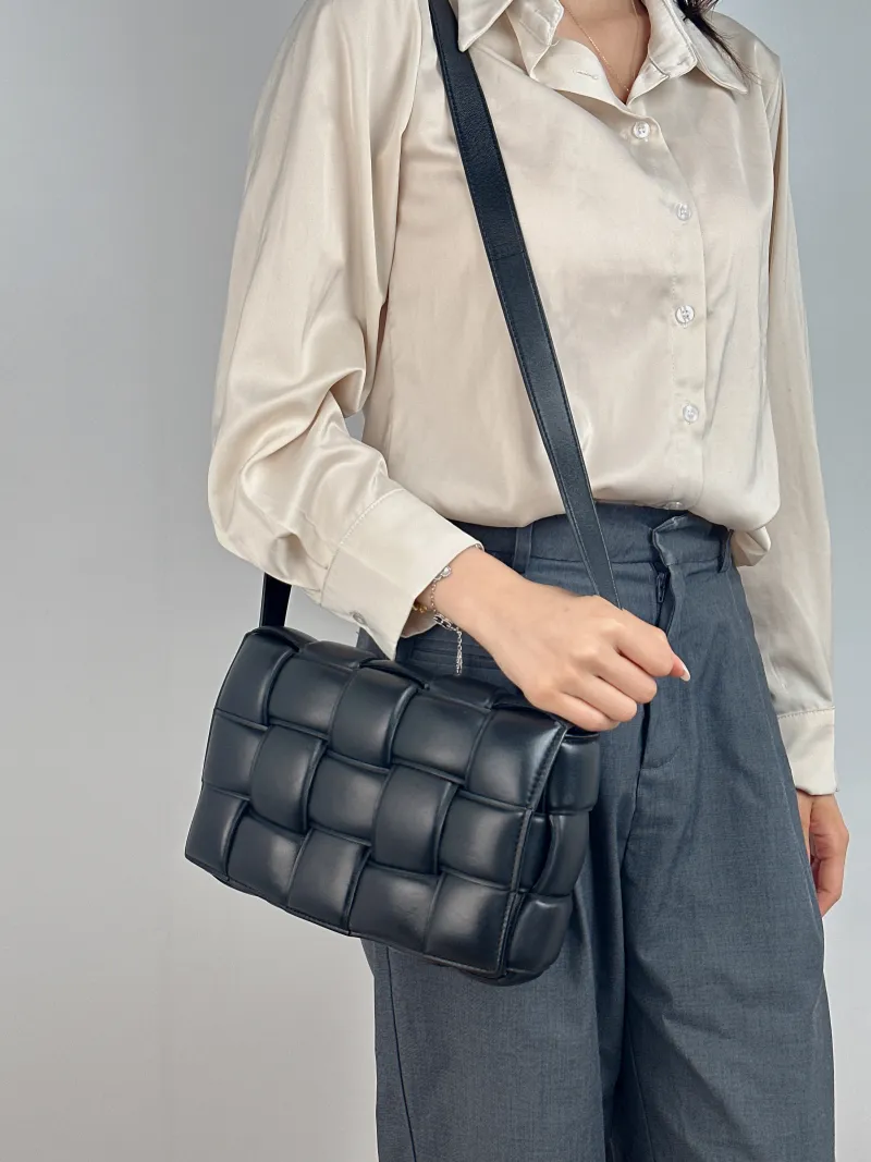 Bottega Veneta Crossbody Bag Padded Cassette Woven Black Lambskin Medium 26 × 8 × 18 cm — on-model view 1 of 2