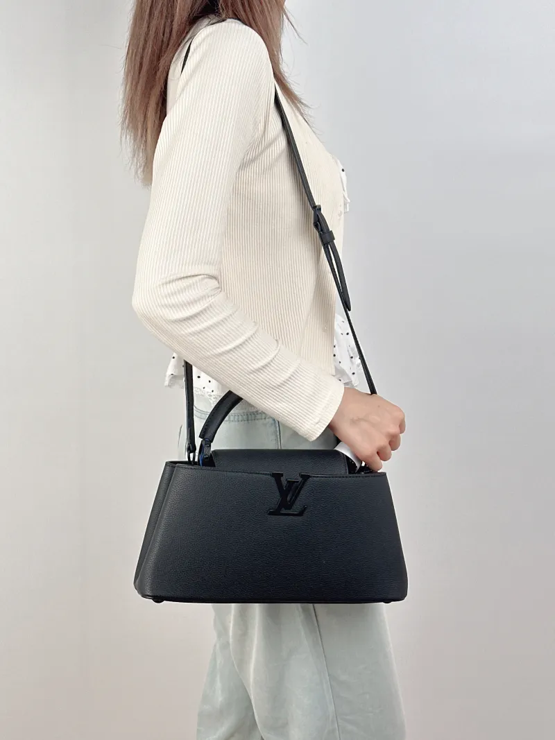 Louis Vuitton Top Handle Bag Capucines East West Black Calfskin Medium33 × 9 × 19 cm — on-model view 1 of 3