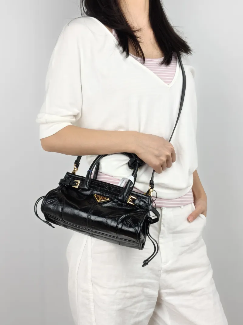 PRADA Shoulder Bag Bonnie Soft Lux Black Waxed Leather Mini 23.5 × 9 × 12 cm — on-model view 1 of 3