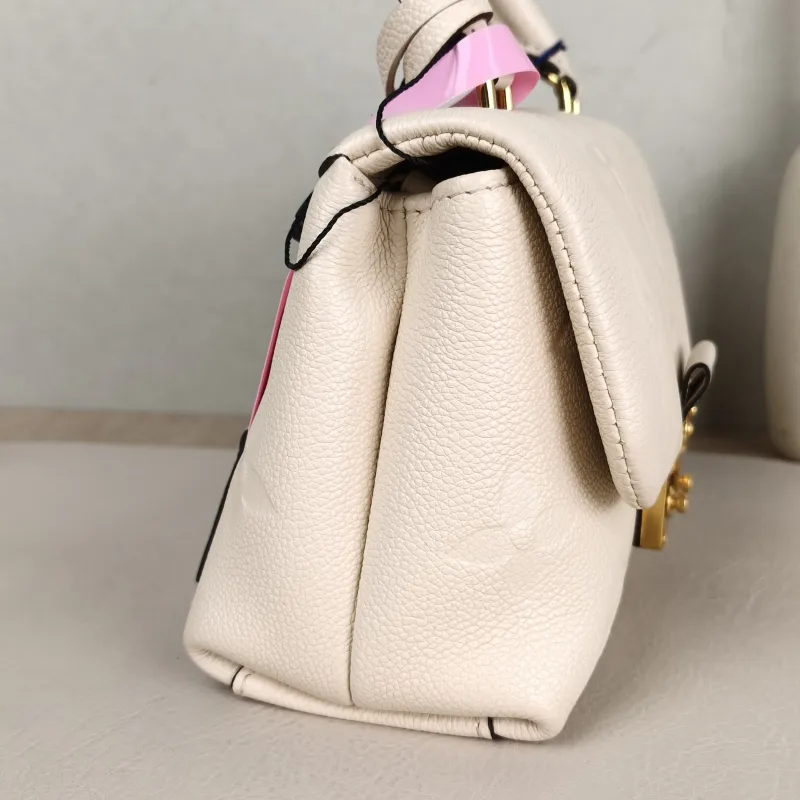 Louis Vuitton Crossbody Bag MADELEINE White Monogram Empreinte Embossed Calfskin BB 24 × 8.5 × 17 cm — detail view 8 of 14