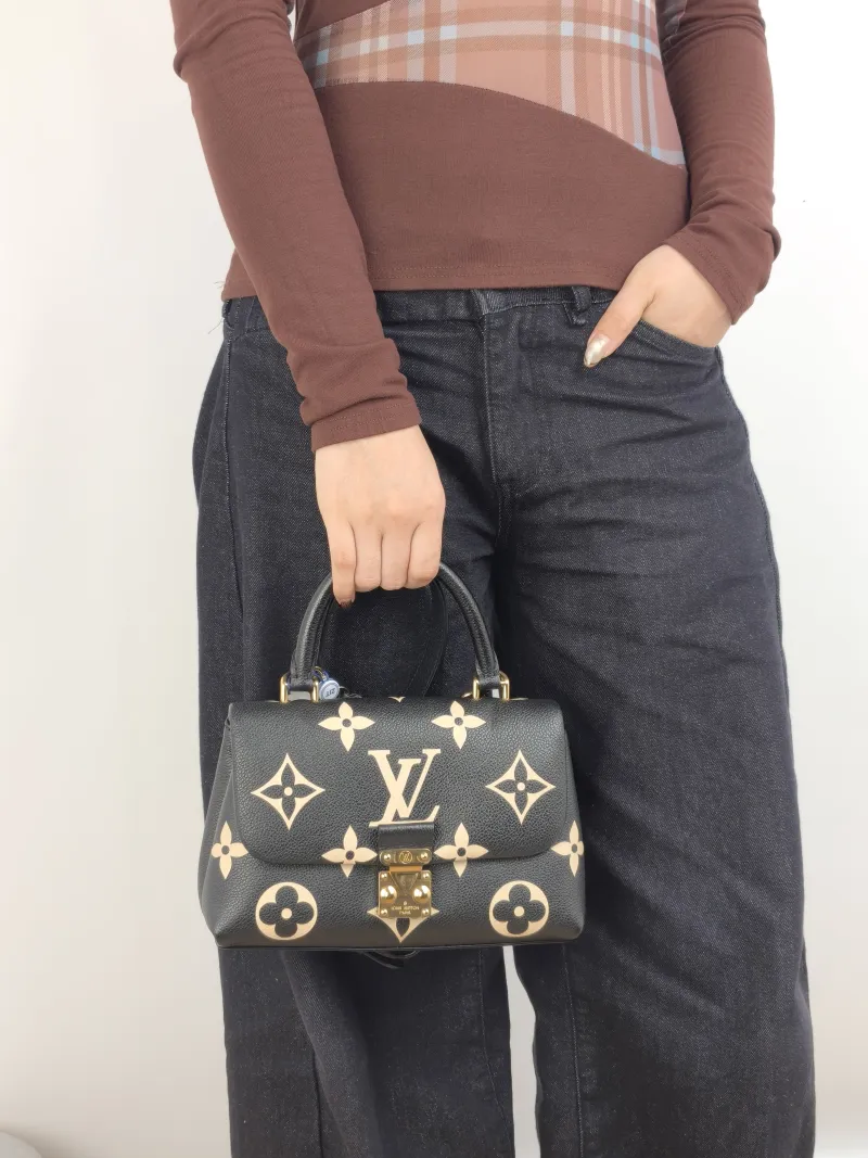 Louis Vuitton Crossbody Bag MADELEINE Black · White Monogram Empreinte Embossed Calfskin BB 24 × 8.5 × 17 cm — on-model view 2 of 3