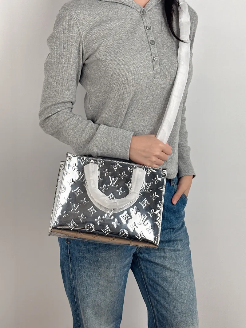 Louis Vuitton Top Handle Bag Onthego Silver Patent Leather Small 25 × 11.5 × 19 cm — on-model view 2 of 3