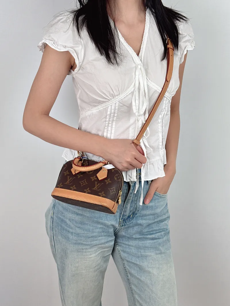 Louis Vuitton Crossbody Bag Alma Nano Monogram PVC nano 18 × 8 × 12 cm — on-model view 2 of 3