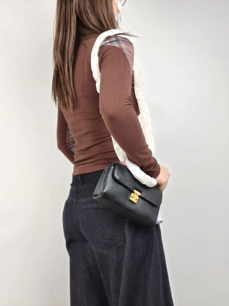 Louis Vuitton Crossbody Bag MADELEINE Black Monogram Empreinte Embossed Calfskin nano 21 × 6 × 12.5 cm — on-model view 1 of 2
