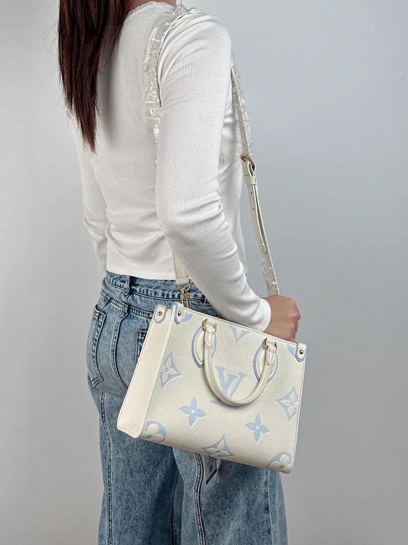 Louis Vuitton Shoulder Bag Onthego White · Blue Monogram Empreinte Embossed Calfskin Small 25 × 11.5 × 19 cm — on-model view 2 of 3