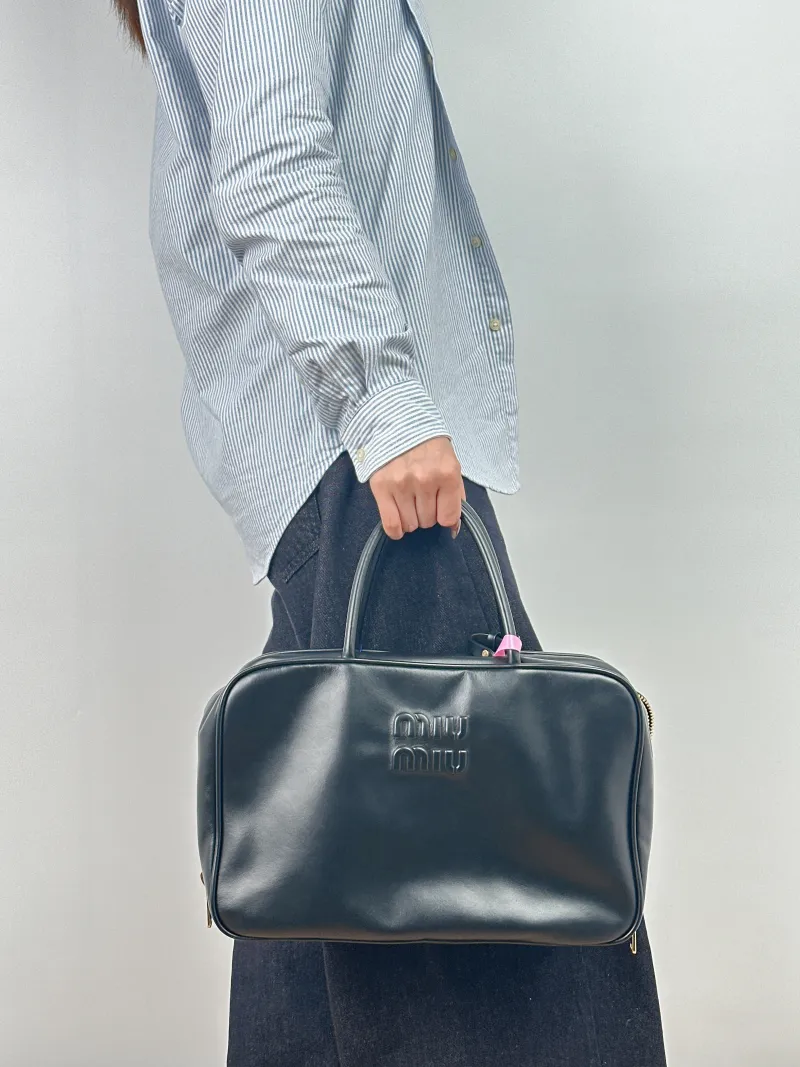 Miumiu Top Handle Bag Beau Black Calfskin Large 34 × 10 × 23 cm — on-model view 2 of 2