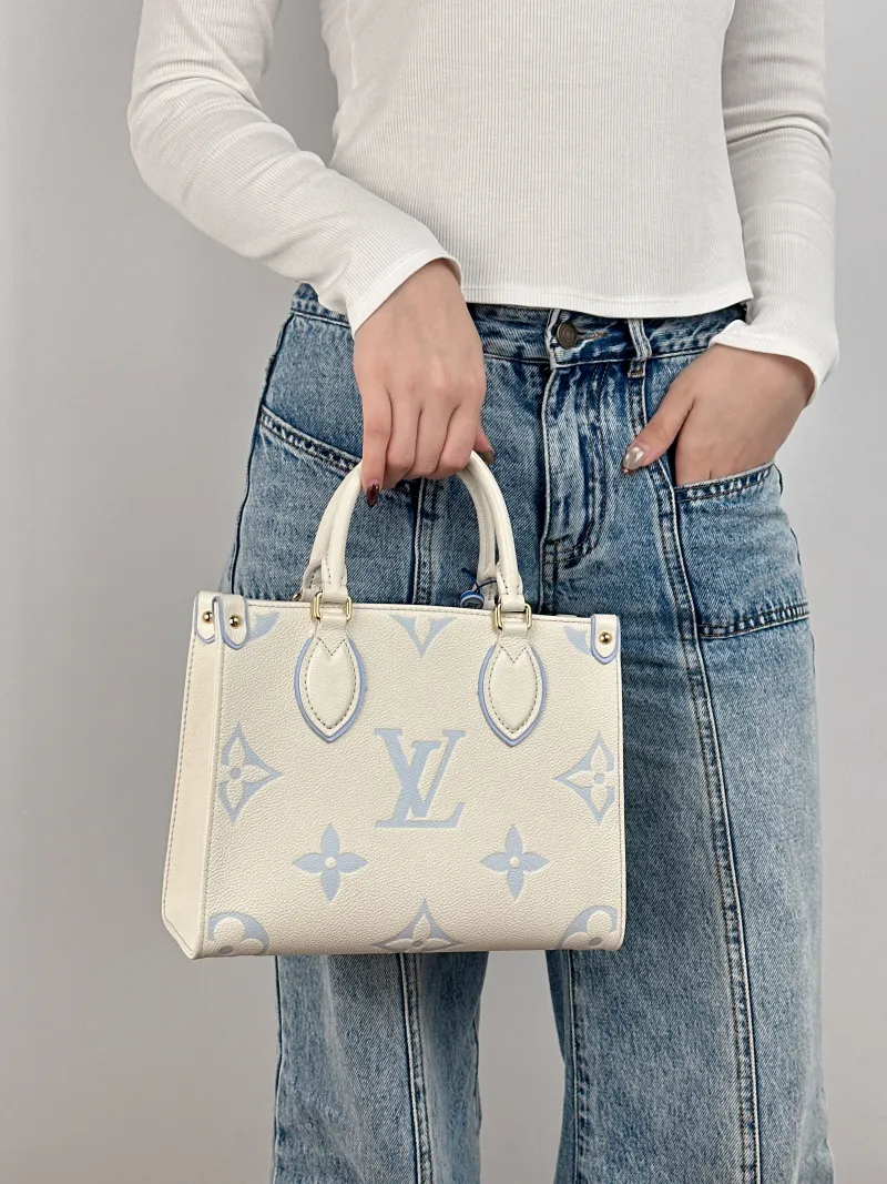 Louis Vuitton Shoulder Bag Onthego White · Blue Monogram Empreinte Embossed Calfskin Small 25 × 11.5 × 19 cm — on-model view 3 of 3