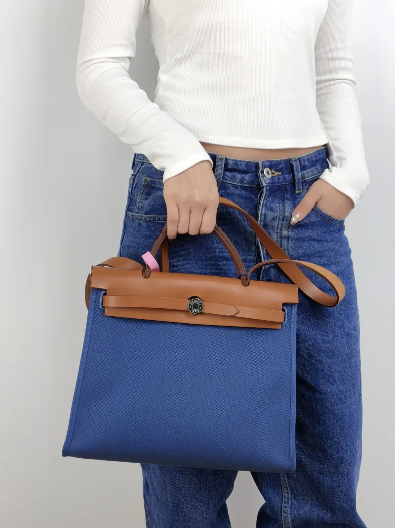 Hermès Crossbody Bag Herbag 31 Blue Caramel Canvas Medium 30.5 × 11 × 25.5 cm Y — on-model view 1 of 2