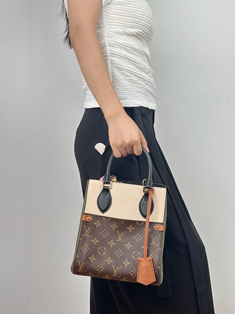 Louis Vuitton Top Handle Bag Fold Tote Colorblock PVC · Calfskin Small 20 × 18 × 22 cm — on-model view 2 of 2