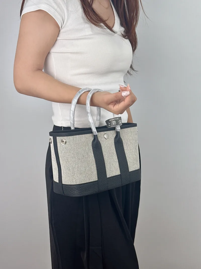 Hermès Top Handle Bag Neo Garden 23 Mini Black · Beige Canvas · Negonda Calfskin Mini 23 × 10 × 16 cm G — on-model view 1 of 2