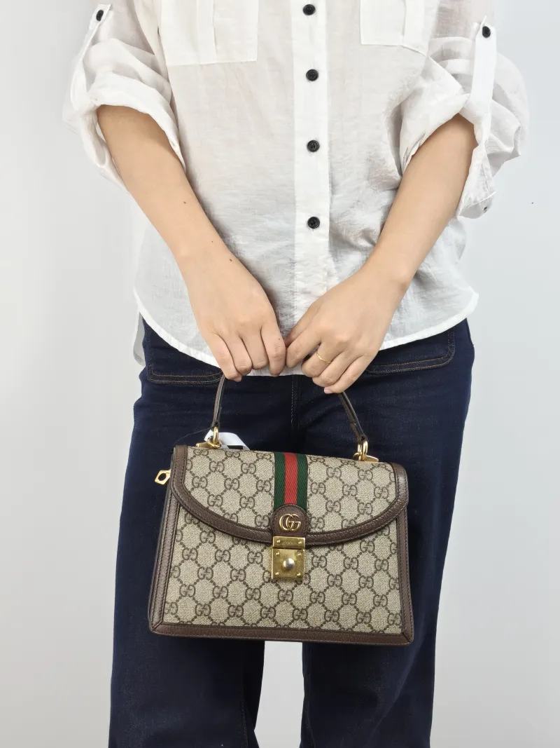 GUCCI Top Handle Bag Ophidia GG Messenger Bag Monogram PVC Medium 25 × 7 × 17.5 cm — on-model view 1 of 2