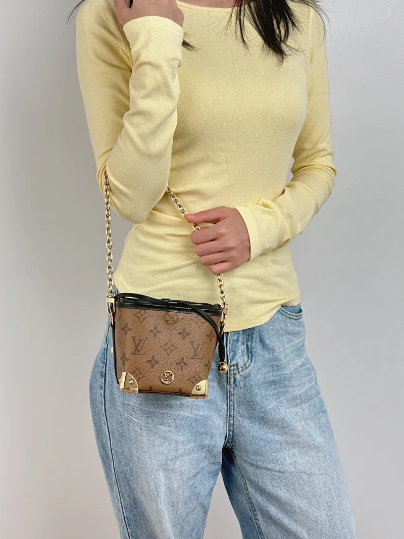 Louis Vuitton Crossbody Bag NOÉ PURSE LV CHARMS Monogram PVC Mini 11.5 × 11.5 × 11.5 cm — on-model view 2 of 3