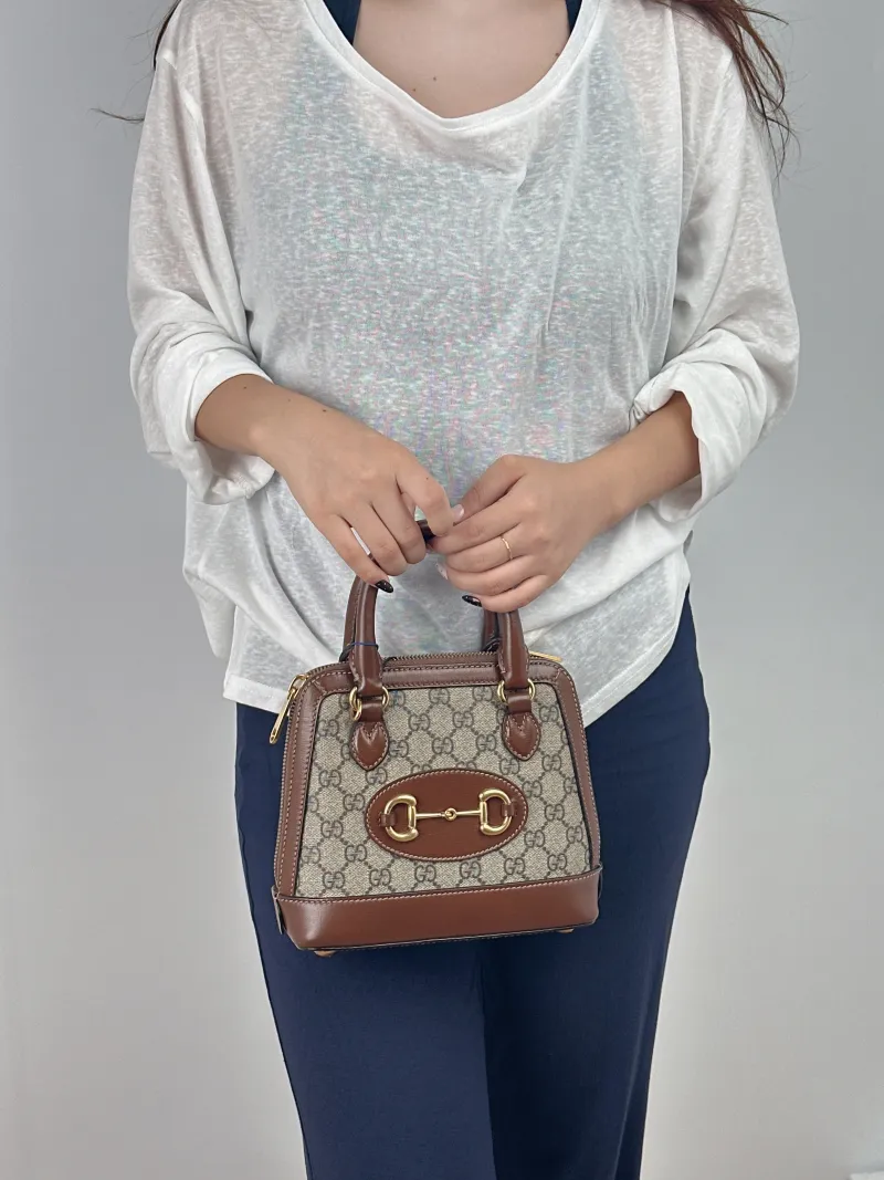 GUCCI Top Handle Bag Horsebit 1955 Horsebit Dome Bag Monogram PVC Mini 20 × 7.5 × 19.5 cm — on-model view 2 of 2