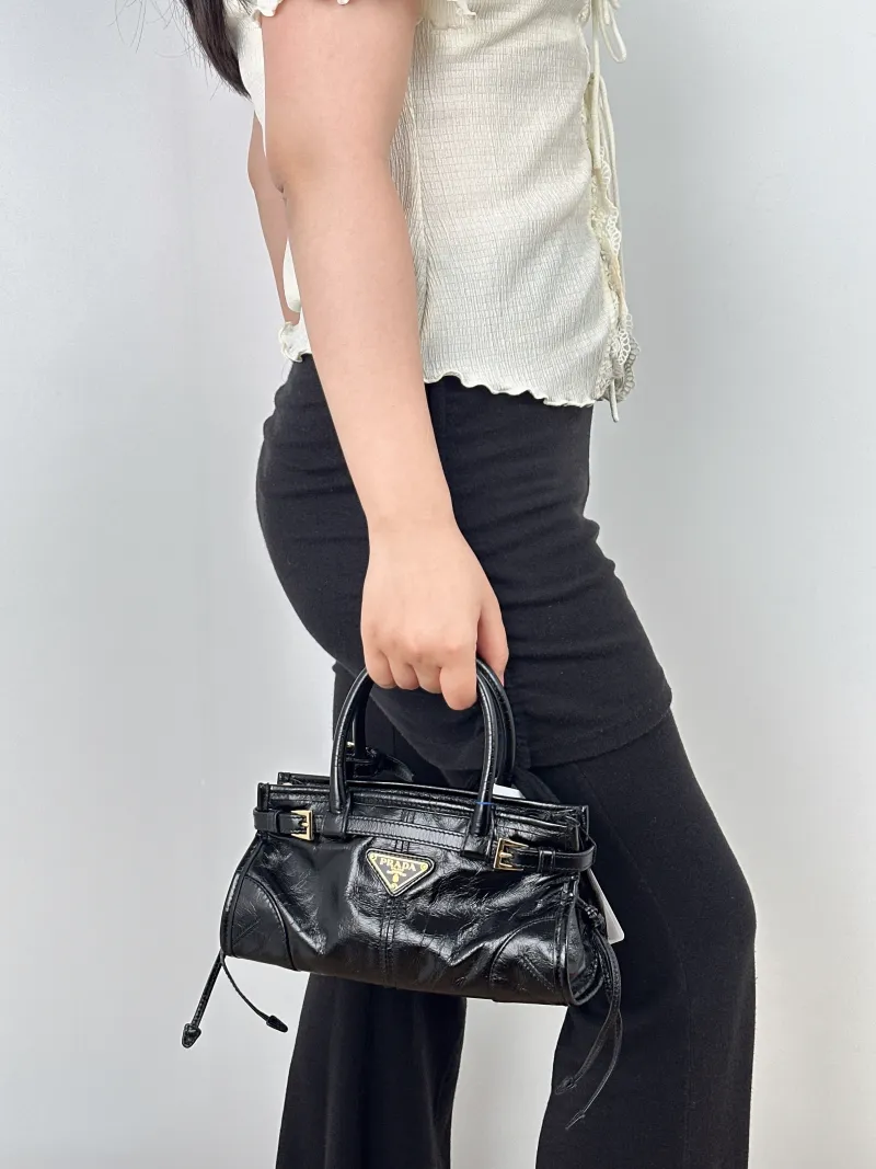 PRADA Shoulder Bag Bonnie Soft Lux Black Waxed Leathermini23.5 × 9 × 12 cm — on-model view 1 of 2
