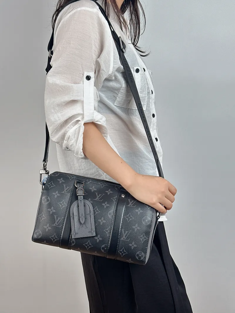 Louis Vuitton Crossbody Bag City Keepall Black PVC Medium 27 × 13 × 17 cm — on-model view 1 of 2