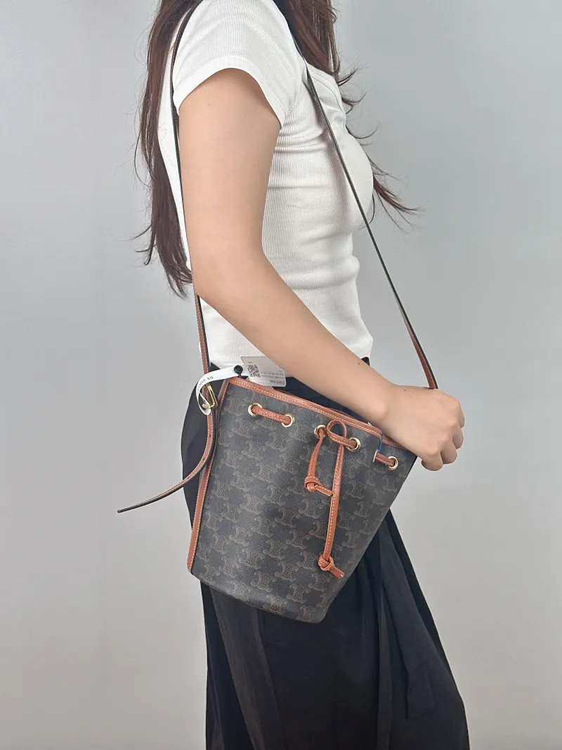 CELINE Crossbody Bag Triomphe Bucket Bag Monogram PVC Small 14 × 14 × 21 cm — on-model view 2 of 2