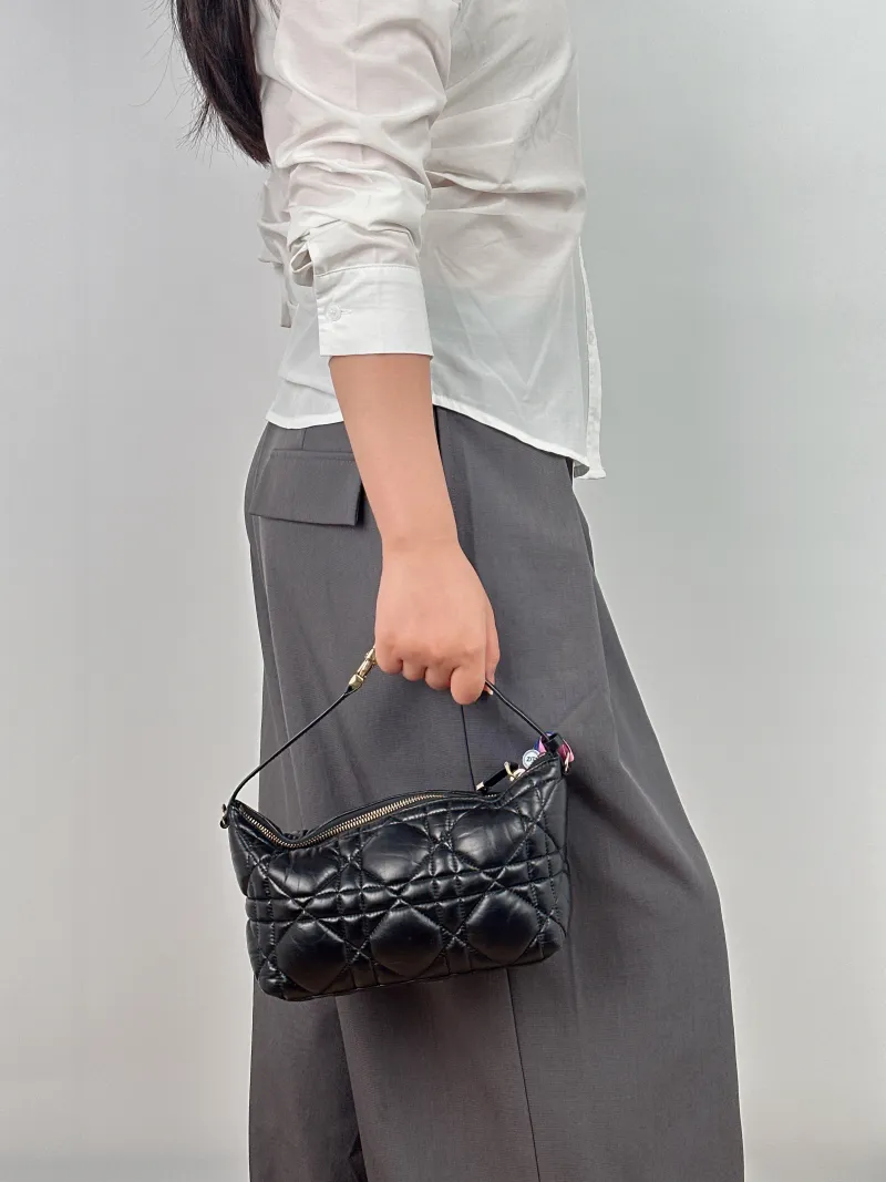 DIOR Top Handle Bag Travel Nomad Black Calfskin Medium 22 × 9.5 × 13 cm — on-model view 2 of 2