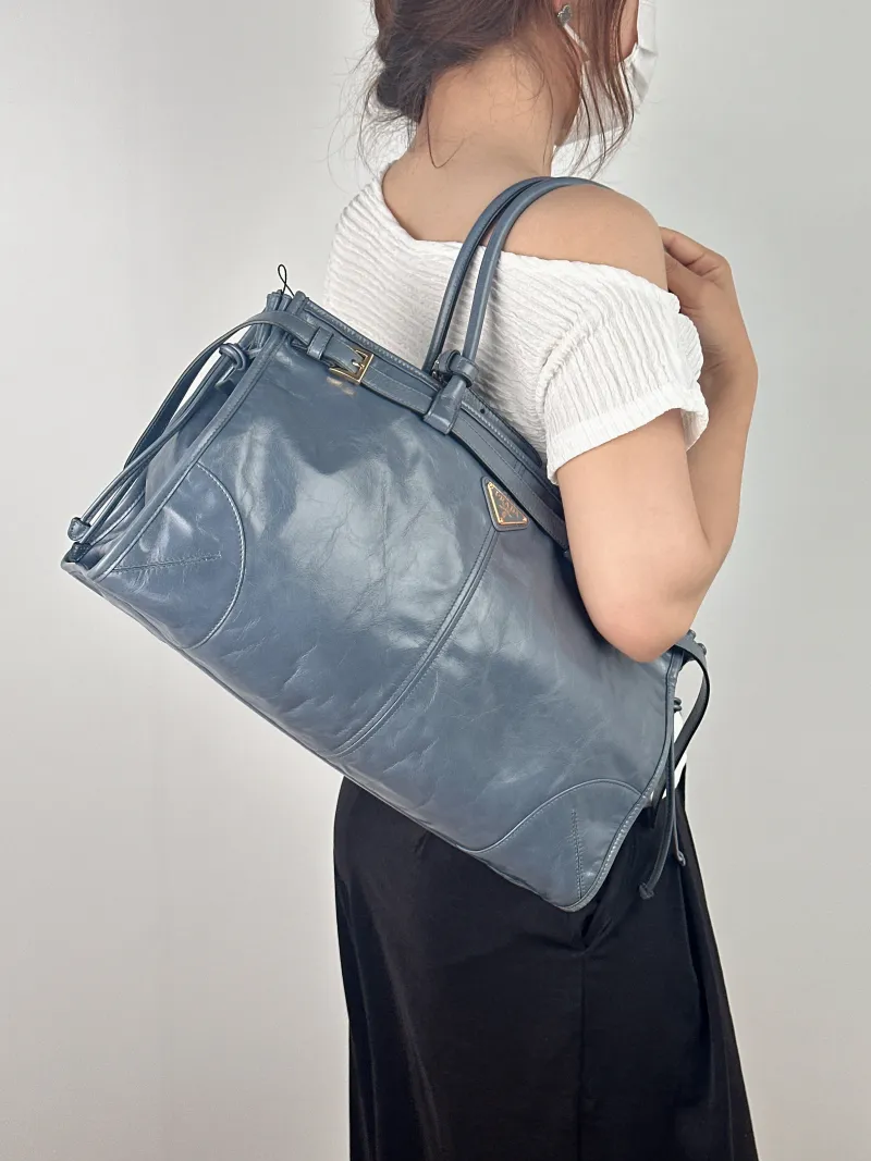 PRADA Shoulder Bag Bonnie Soft Lux Blue Waxed Leather Large 38 × 12 × 24 cm — on-model view 1 of 2
