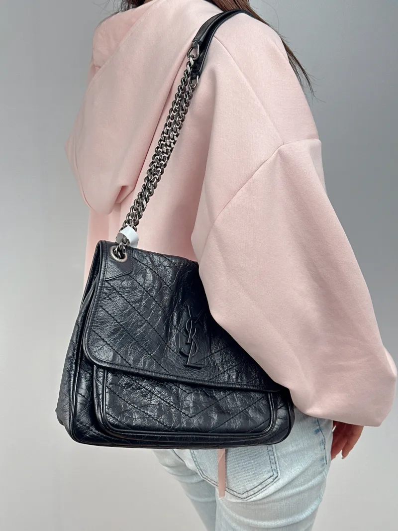 SAINT LAURENT Crossbody Bag Niki D Waxed Leather Calfskin Medium 28 × 8.5 × 20 cm — on-model view 1 of 2